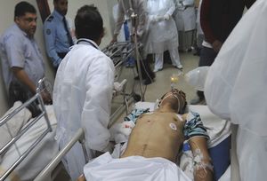 Medical staff of the Salmaniya Medical Complex rush a victim of the clashes between security forces and opposition protesters to the hospital in Manama, Bahrain