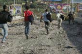 Lebanese civilians sprint past a bombed area 