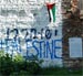 “Israeli” Former Captain Sprays Sacred Wall with Pro-Palestinian Graffiti, Hanged Palestinian Flag 