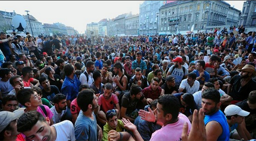 Migrants sit in front of the Keleti [East] railway station in Budapest 