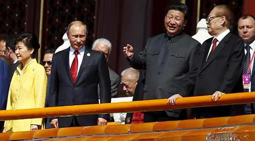 Chinese President Xi Jinping (2nd R) talks to former President Jiang Zemin (R) next to Russia's President Vladimir Putin (2nd L) and South Korea's President Park Geun-hye on the Tiananmen Gate in Beijing, China, September 3, 2015