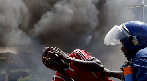 Burundi police and protester